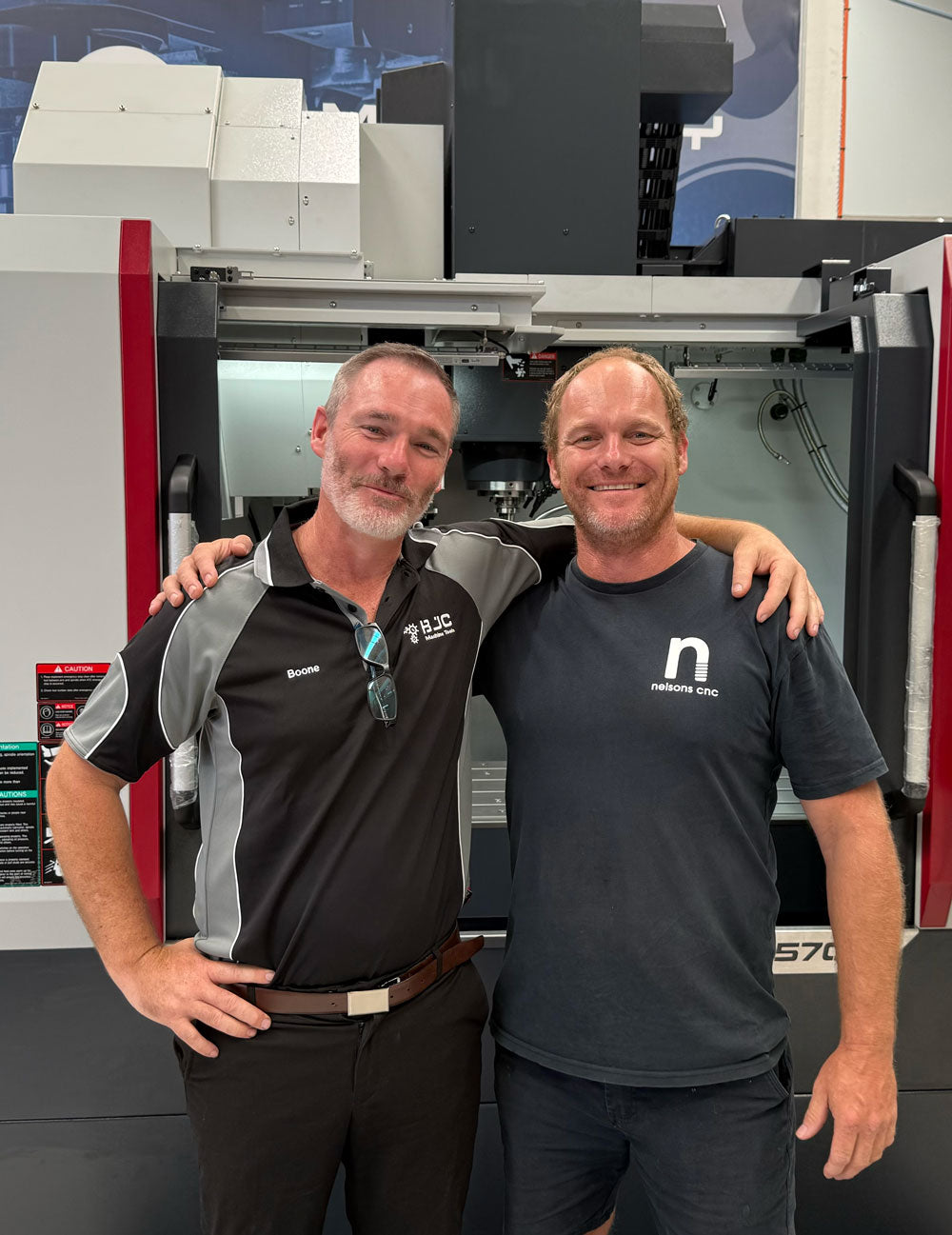 Charlie Nelson standing beside CNC machining centres at Nelsons CNC aluminium end cap facility