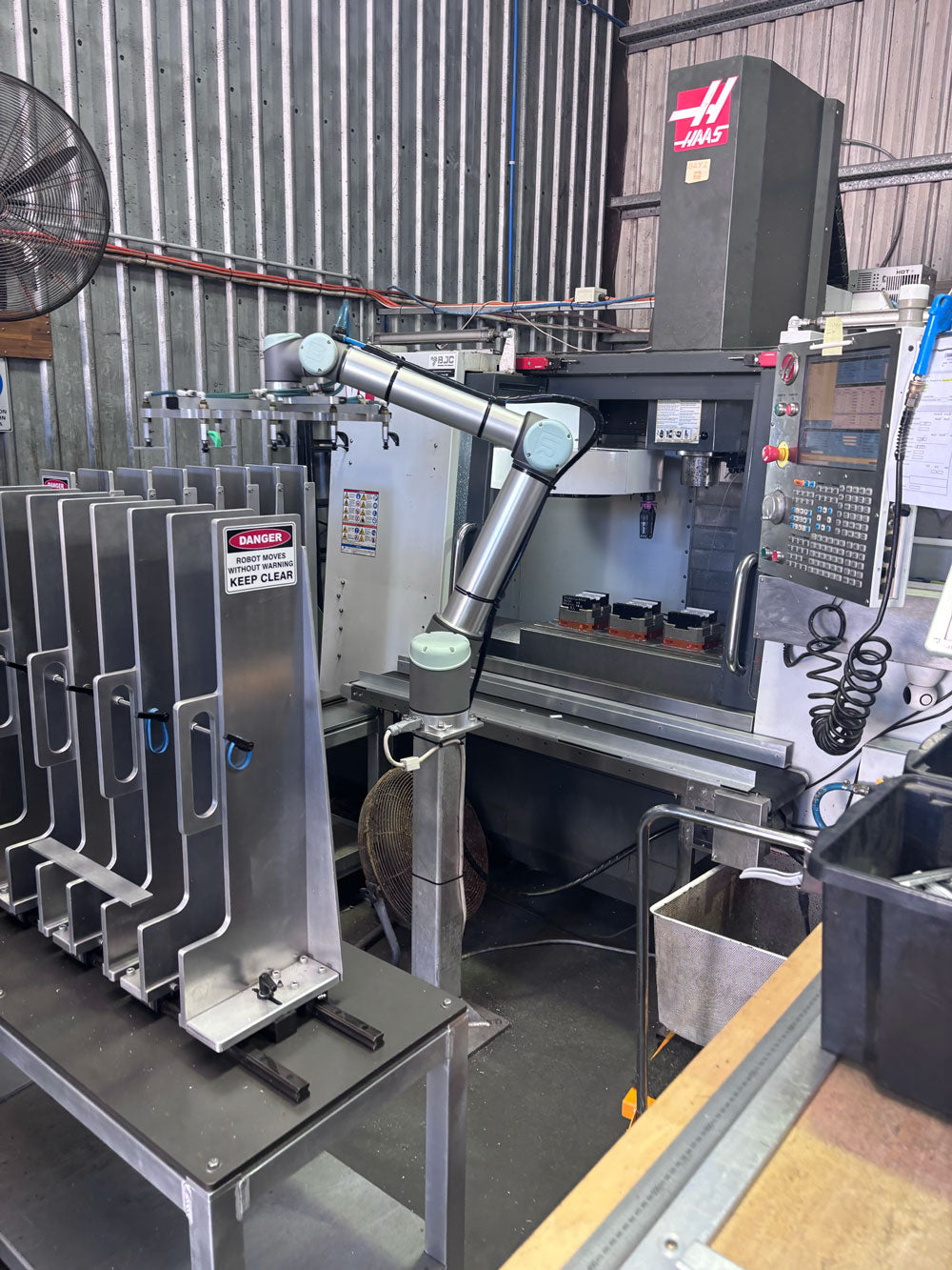 Robotic arm handling aluminium end cap production at Nelsons CNC Pty Ltd manufacturing facility